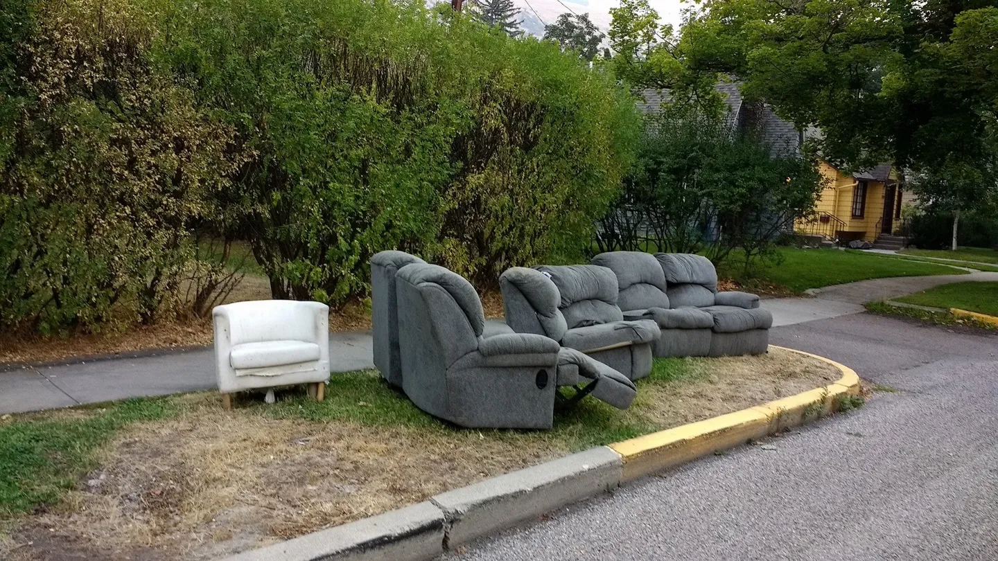 Discarded sofas and armchairs waiting for furniture removal